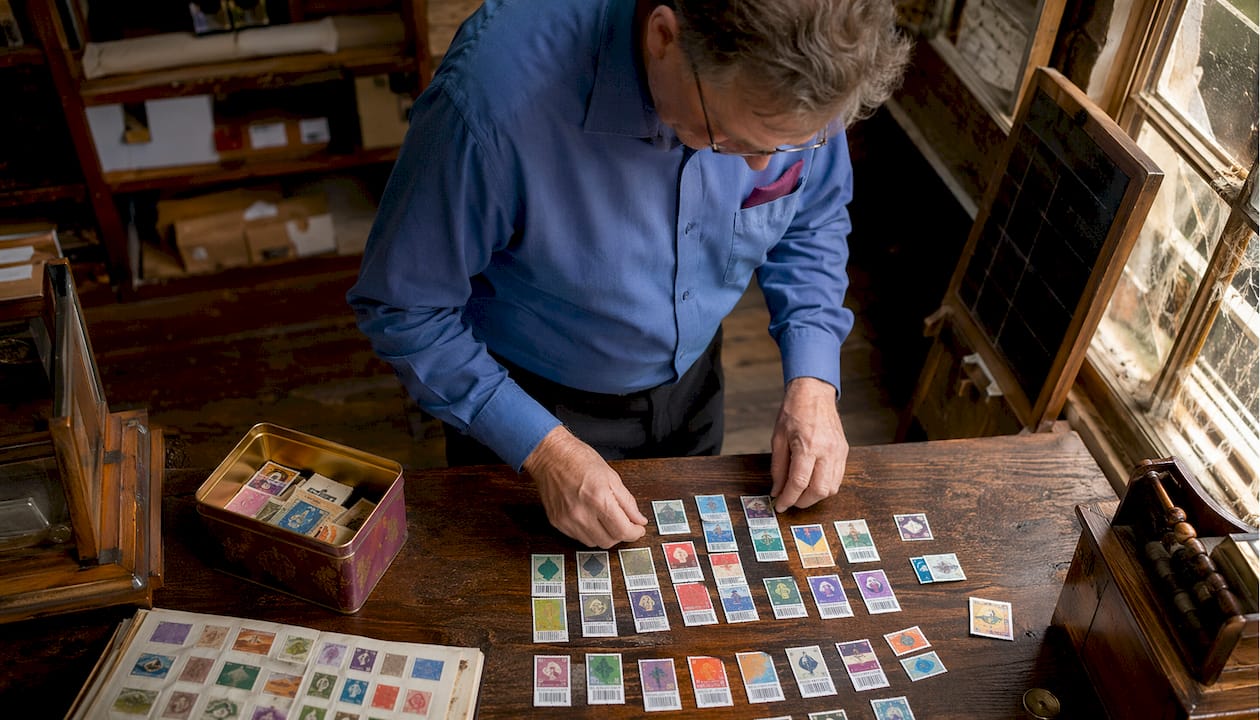 Postal worker arranging barcoded stamps