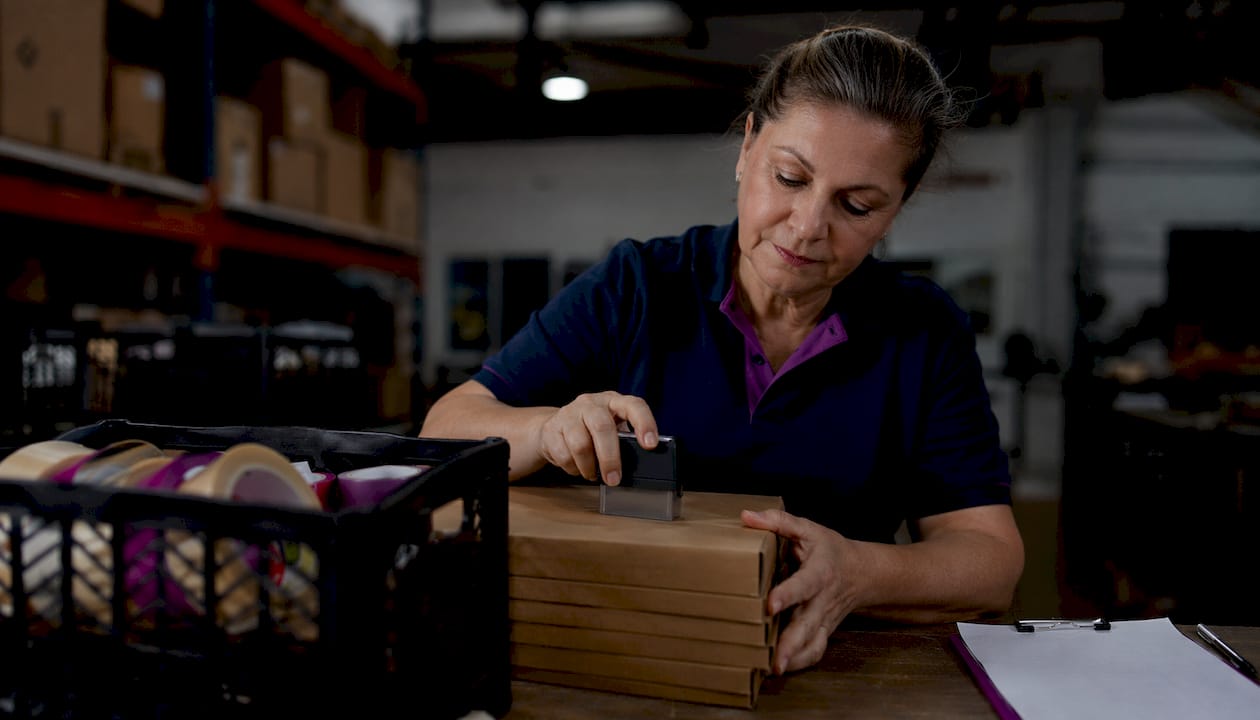 Operator stamping parcel with precise impression
