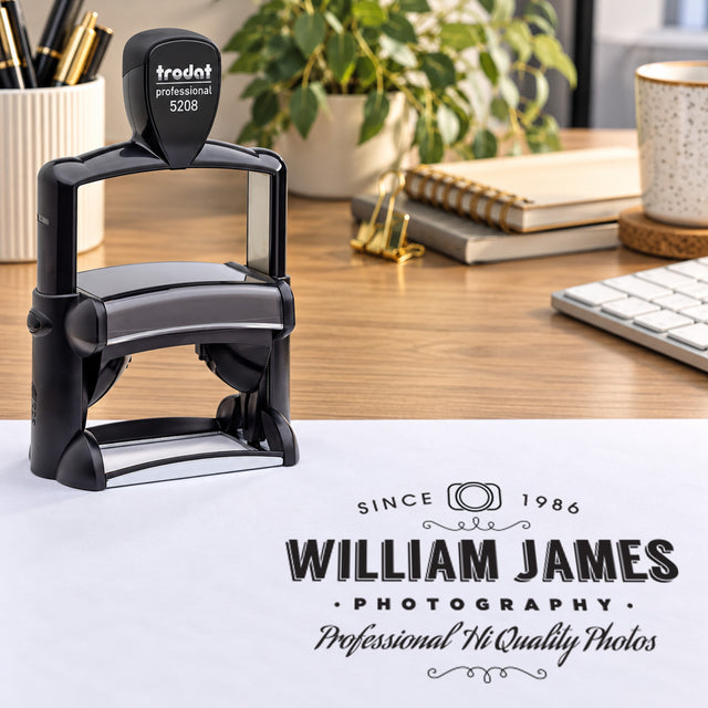 Trodat Professional 5208 on a desk beside a sample William James Photography logo impression