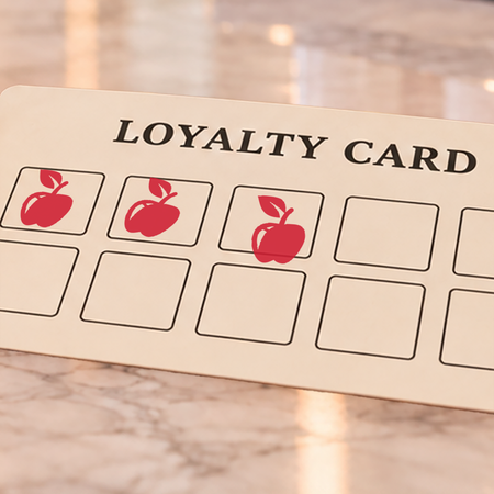 Close-up of red apple impressions on an example loyalty card