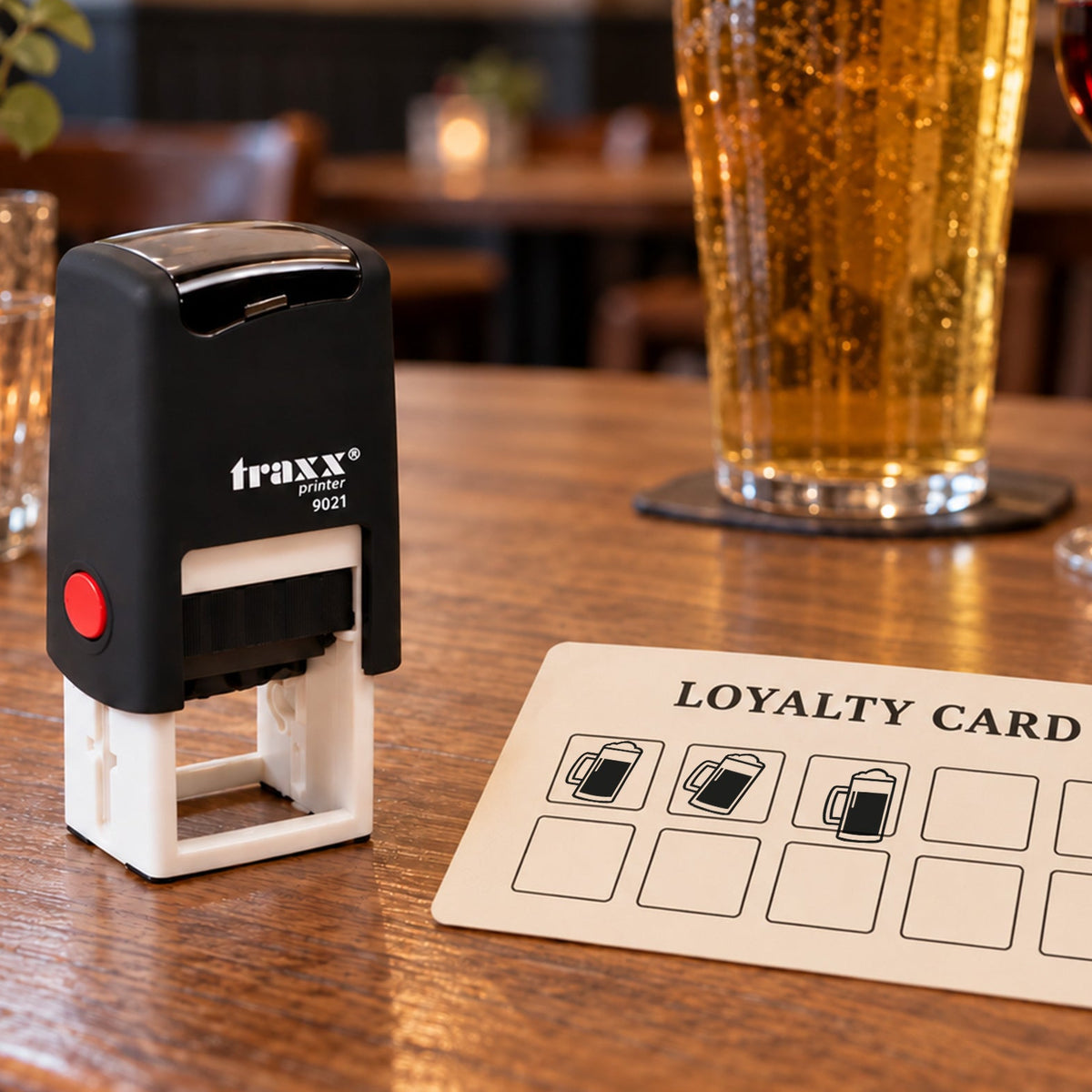 Traxx 9021 beer loyalty stamp with black impressions on an example card