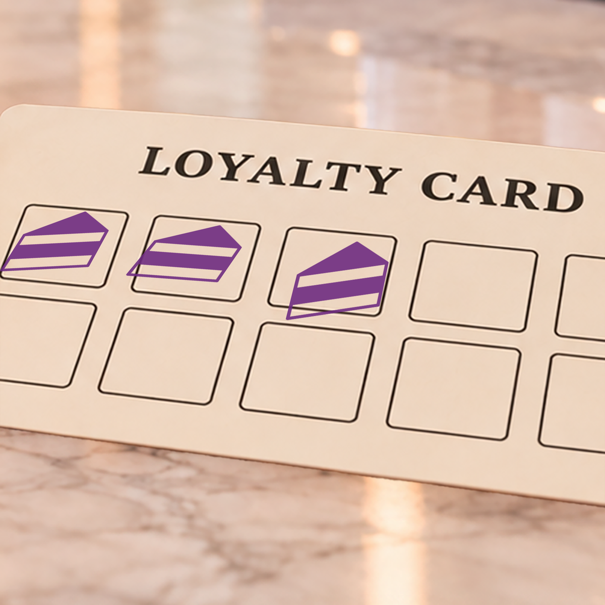 Close-up of violet cake impressions on an example loyalty card