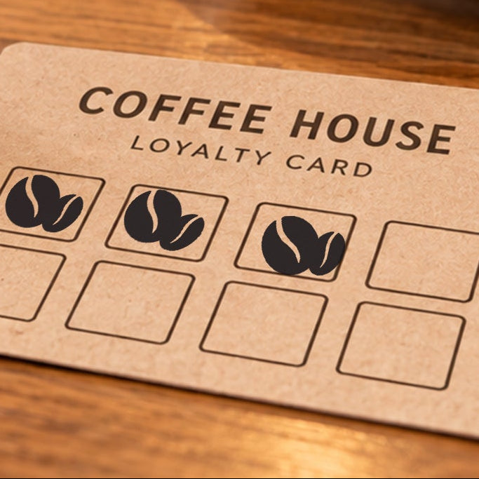 Close-up of black coffee bean impressions on an example loyalty card