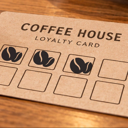 Close-up of black coffee bean impressions on an example loyalty card