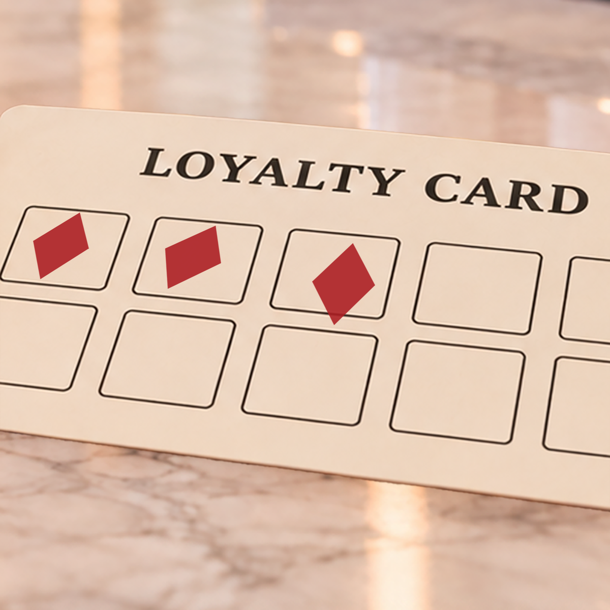 Close-up of red diamond impressions on an example loyalty card