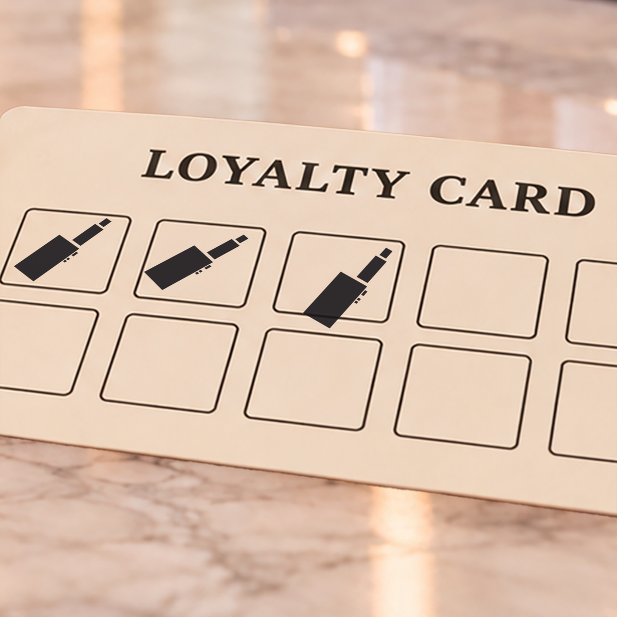Close-up of black e-cig impressions on an example loyalty card