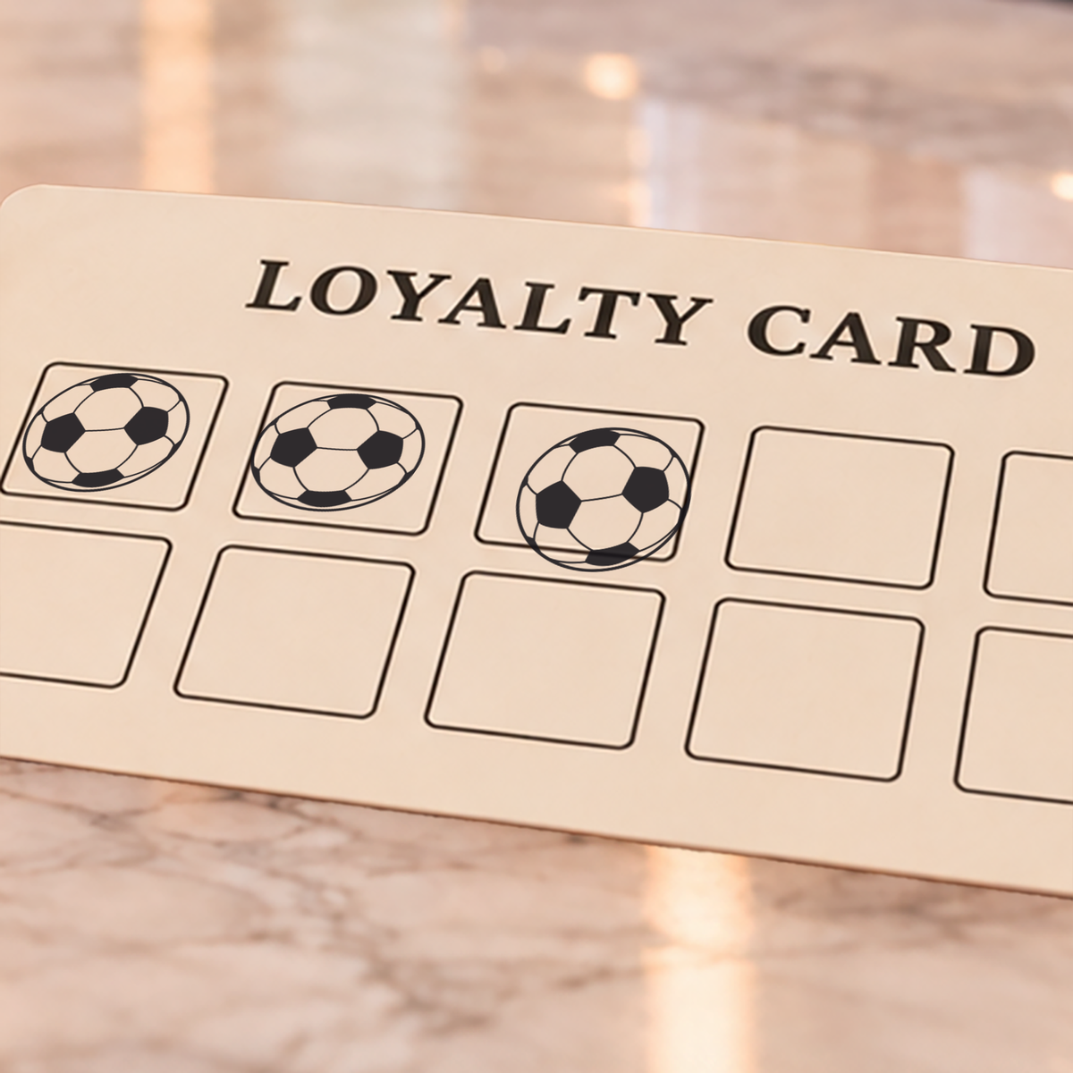 Close-up of black football impressions on an example loyalty card