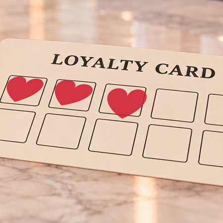Close-up of red heart impressions on an example loyalty card