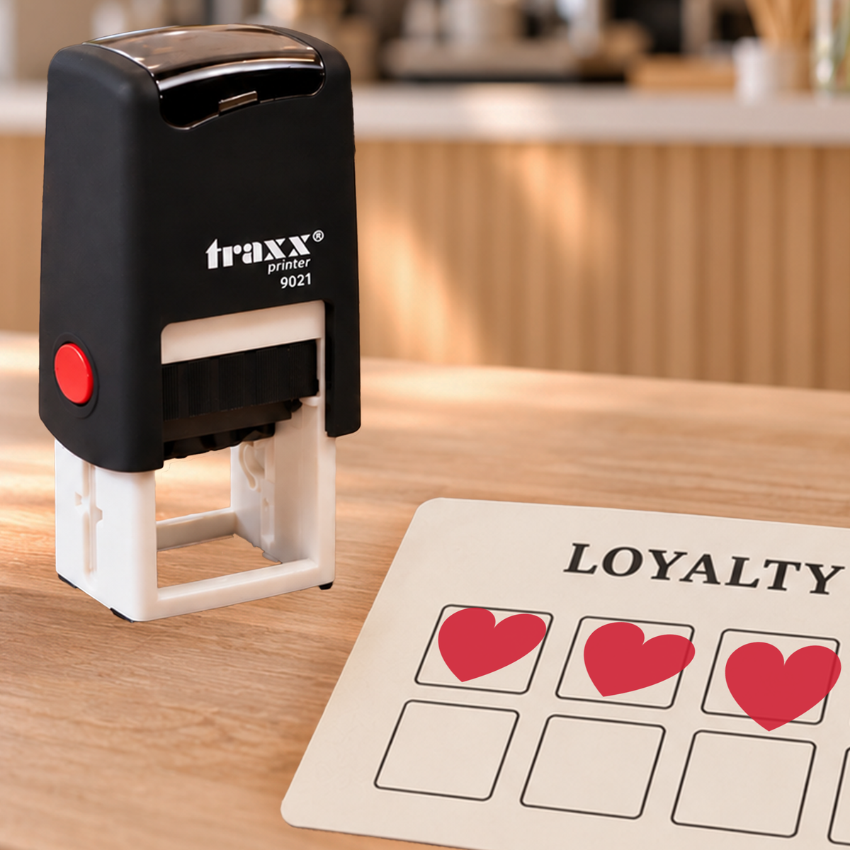 Traxx 9021 heart loyalty stamp with red impressions on an example card