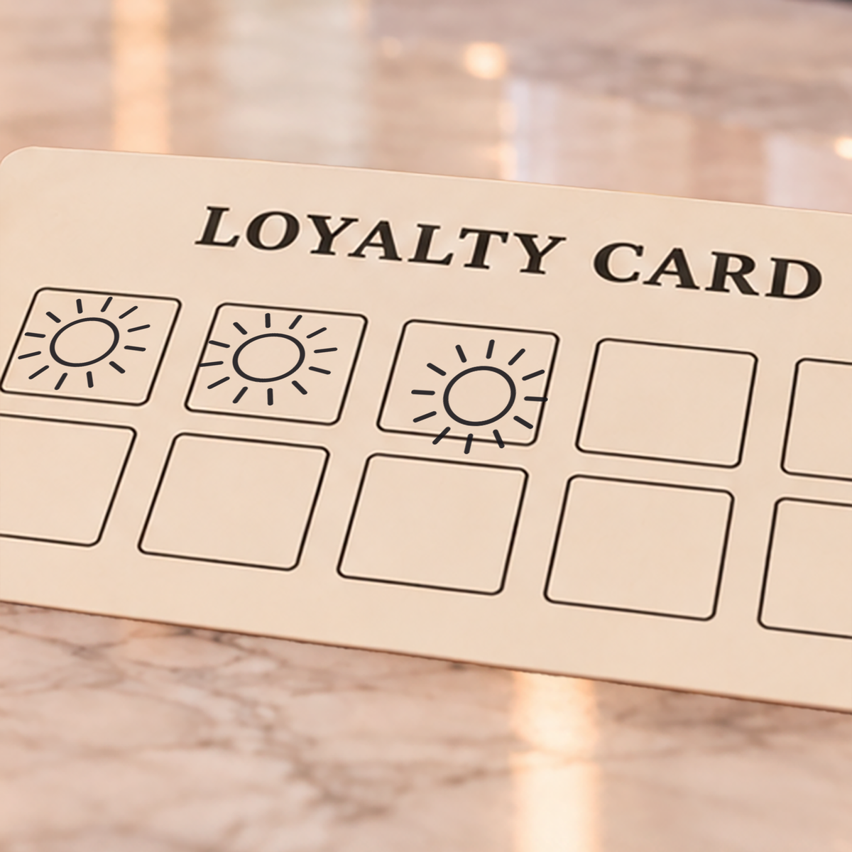 Close-up of black sun impressions on an example loyalty card
