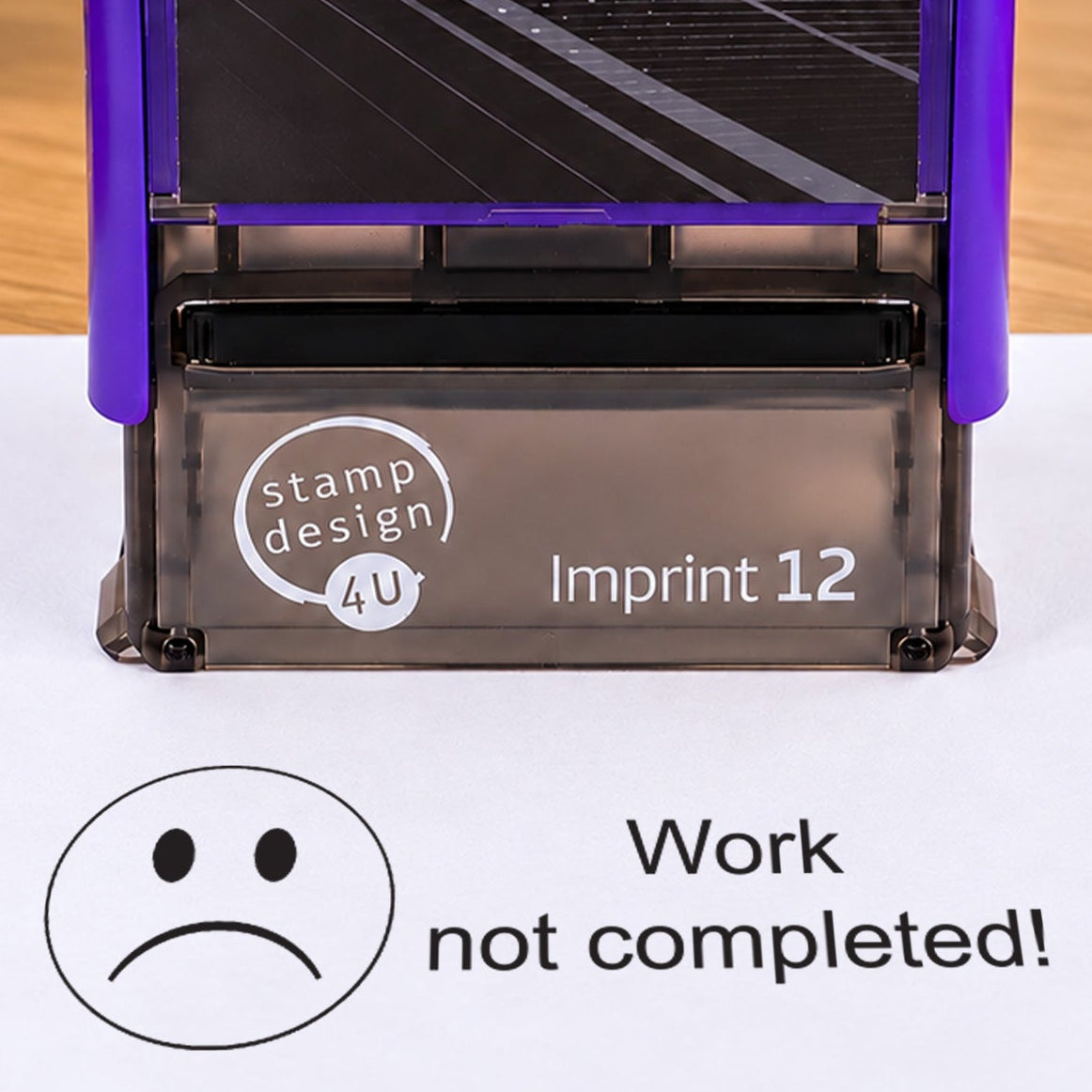 Work Not Completed teacher stamp: close-up of the pictured Imprint 12 casing and black sad-face impression