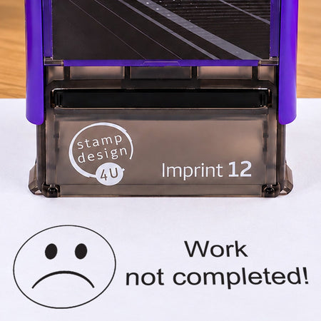 Work Not Completed teacher stamp: close-up of the pictured Imprint 12 casing and black sad-face impression