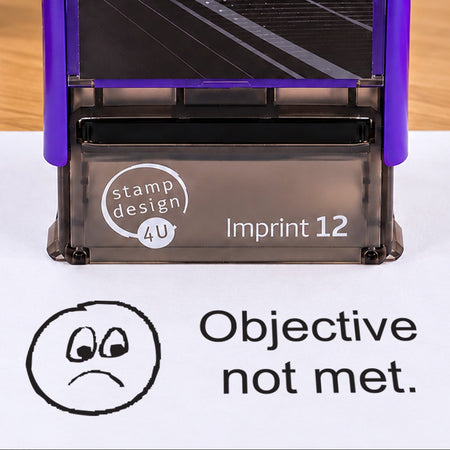 Objective Not Met teacher stamp: close-up of the pictured Imprint 12 casing and black sad-face impression