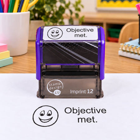 Objective Met teacher stamp: pictured purple Imprint 12 casing with black smiling-face impression