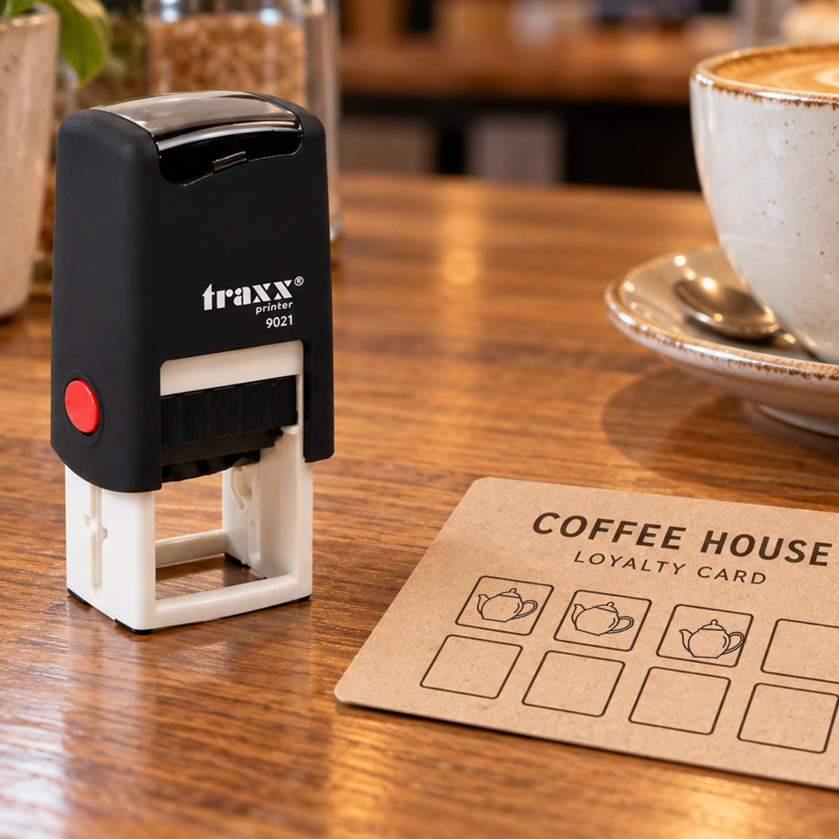 Traxx 9021 teapot loyalty stamp with black impressions on an example card