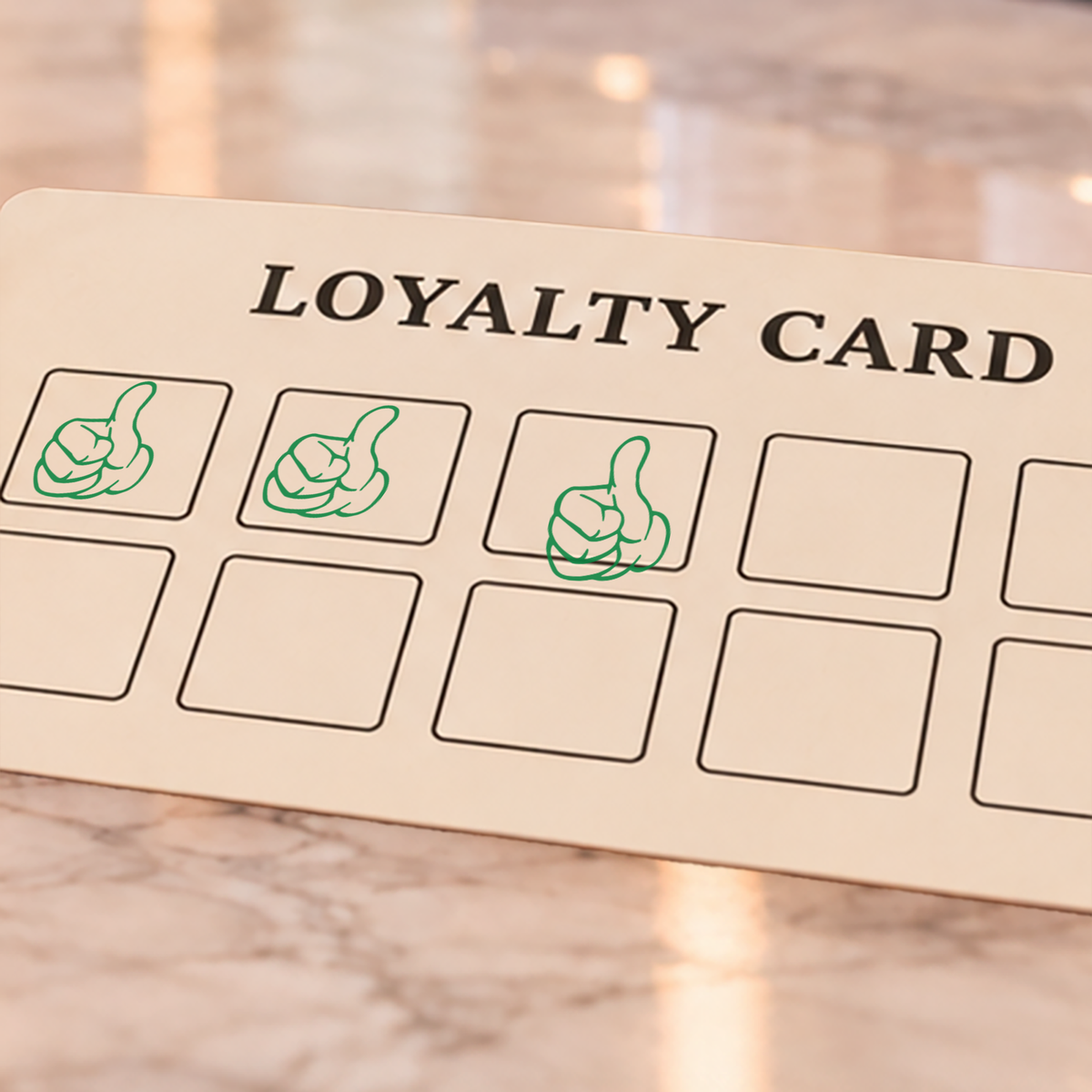 Close-up of green thumbs up impressions on an example loyalty card