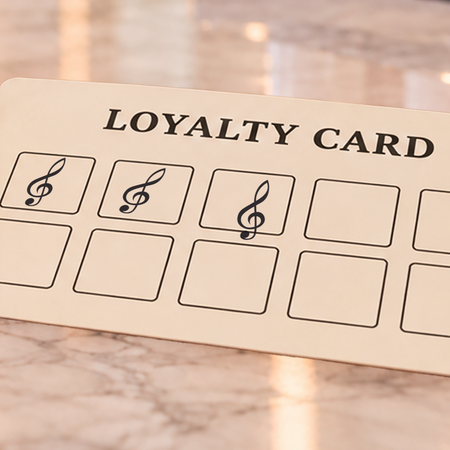 Close-up of black treble clef impressions on an example loyalty card