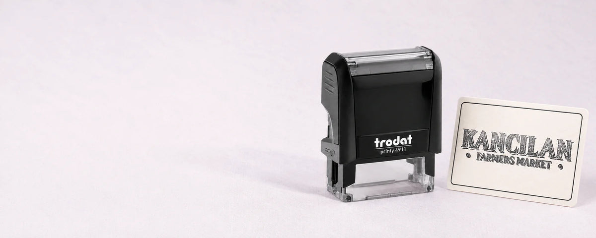 Trodat Printy 4911 small logo stamp beside its matching farmers market logo impression